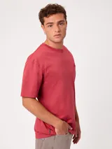 Remera negra de corte suelto y mangas cortas, con pequeño bordado a tono en el pecho.