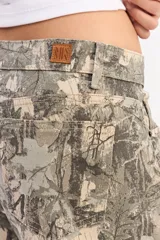 Jean de corte recto y tiro medio con estampado camuflado de estilo forestal. Presenta cierre frontal con botón y bolsillos laterales y traseros.