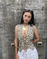 Chaleco con estampado animal print de leopardo, escote en V pronunciado y cierre frontal con lazos ajustables.