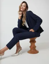 Pantalón sastrero slim color azul marino, de tiro alto con pretina anatómica, pinzas frontales, cierre oculto y bolsillos laterales inclinados.
