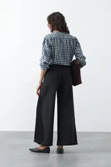 Jean de calce ultra wide confeccionado en denim de algodón color negro. Presenta una silueta amplia desde la cadera y un panel lateral en contraste que estiliza la pierna.