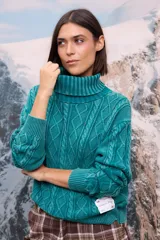 Buzo de punto con cuello polera, diseño de trama trenzada y efecto gastado, de corte holgado y mangas largas con puños acanalados.