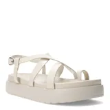Sandalias de plataforma plana color blanco, con diseño de tiras cruzadas y sujeción para el dedo. Cuentan con cierre de hebilla lateral ajustable.