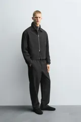 Sobrecamisa regular fit color gris oscuro, confeccionada en tejido con viscosa. Presenta cuello solapa, manga larga con puño abotonado, bolsillos de vivo en la cadera y cierre frontal con cremallera.