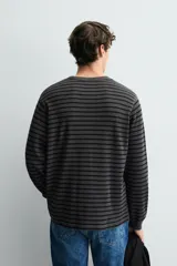 Camiseta de manga larga con cuello redondo, confeccionada en tejido de algodón con textura tipo waffle y acabados en rib.