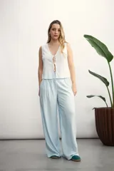 Pantalón de corte sastrero y tiro alto, con diseño de pierna ancha y pinzas frontales. Cuenta con bolsillos laterales y cierre frontal con botón oculto.