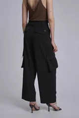Pantalón cargo negro de corte ancho, con bolsillos laterales con fuelle y trabillas en la cintura.