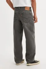 Jean de hombre color gris oscuro, de corte recto y holgado, con tiro bajo y cierre de bragueta. Cuenta con cinco bolsillos.