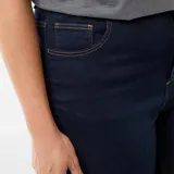 Pantalón de jean tipo skinny, color azul oscuro, con tiro muy alto y cierre frontal de botones expuestos.