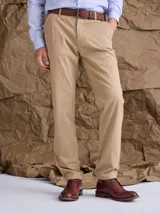 Pantalón de gabardina color beige, de corte recto y estilo clásico, con cierre de botón y cremallera.