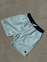 Short de baño celeste con estampado de letras y cintura elástica negra con cordón ajustable.