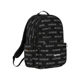Mochila Supreme de color negro con estampado integral de la marca en tono gris y un bolsillo frontal con el logo clásico en caja roja y blanca.