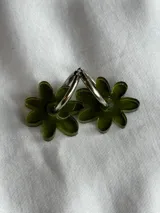 Aros de argolla metálica con dije colgante en forma de flor de acrílico color rosado.