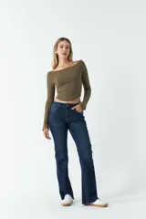 Top de manga larga con cuello bote, confeccionado en tejido acanalado de color verde militar. Presenta un corte ajustado al cuerpo y largo hasta la cintura.