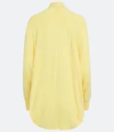 Cardigan alargado en tejido de punto color amarillo, con ribana en los puños y barra redondeada.