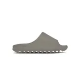 Chancletas Yeezy Slides de una sola pieza, color gris, con diseño minimalista, suela dentada y plantilla texturizada para mayor comodidad.
