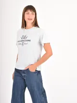 Remera negra de algodón con cuello redondo y mangas cortas, presenta la frase 'Don't text me' estampada en el centro del pecho con tipografía cursiva blanca.