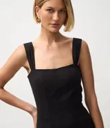 Vestido midi negro de algodón con escote cuadrado y breteles anchos. Presenta un corte recto y pinzas delanteras que añaden movimiento a la prenda.