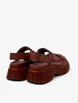 Sandalias marrones de cuero con plataforma gruesa y tiras con ajuste de velcro.