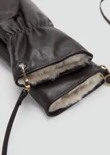 Guante tipo manopla de cuero negro con interior de piel sintética y detalle de lazo ajustable en la muñeca.