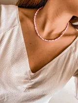 Gargantilla de cuentas rosadas con pequeñas cuentas plateadas intercaladas.