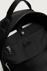 Mochila de nylon negra, con compartimento principal con cierre de cremallera, bolsillo frontal, bolsillos laterales planos y detalles de cuero sintético en la base.