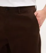 Pantalón de corte recto confeccionado en sarga de algodón con un toque de elastano. Presenta cintura con trabillas para cinturón, cierre tradicional de botón y cremallera, y bolsillos laterales y traseros.
