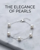 Pulsera de cadena de plata con perlas espaciadas a lo largo de su diseño.