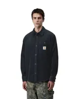 Camisa de manga larga Carhartt confeccionada en pana de algodón, con cierre frontal de botones, cuello clásico y bolsillo en el pecho con etiqueta de la marca.