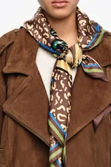 Pañuelo cuadrado de poliéster reciclado con un diseño estampado de diversos animales dentro de una forma de corazón sobre fondo de animal print, y bordes en tonos marrones, verdes y azules.