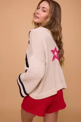 Sweater tejido a máquina manual con bordado a mano. Silueta oversize con mangas anchas y largo por arriba de la cola.