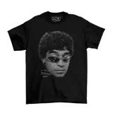 Remera negra de algodón con estampa frontal en escala de grises que muestra un retrato de Diego Maradona con lentes de sol y su firma.