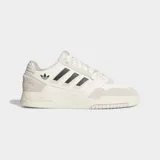 Championes Adidas Drop Step Low 2.0 de estilo urbano, con diseño inspirado en el baloncesto. Presentan una parte superior que combina ante y piel sintética en tonos crema y blanco, con las icónicas tres tiras laterales en color negro y el logo del trébol. Cuentan con una suela de goma esculpida y cierre de cordones.