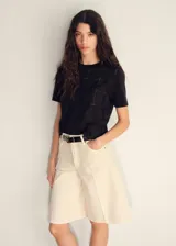 Camiseta negra de manga corta, con cuello redondo y diseño bordado de cuadrillé con detalles geométricos.