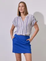 Minifalda azul de gabardina elastizada con pretina ancha elastizada, bolsillos delanteros y short interno.