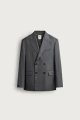 Blazer regular fit de Zara confeccionada en 100% lana, de color gris con diseño de rayas diplomáticas. Presenta cuello con solapas de pico, manga larga con botones en los puños, bolsillos con solapa en la cadera y bolsillo de vivo en el pecho. Cuenta con cierre frontal de botonadura cruzada.