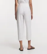 Pantalón tipo pantalona de viscosa color blanco, con cintura mediana, cierre frontal con botones y bolsillos laterales.