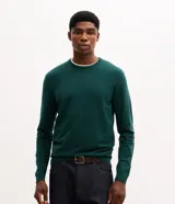 Suéter básico de punto color verde oscuro para hombre, con cuello redondo, mangas largas y puños y bajo acanalados.