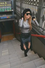 Falda midi negra de gabardina metalizada elastizada, con tachas en la cintura y flecos en el ruedo.