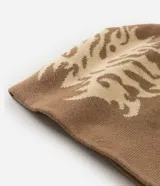 Gorro de punto doble faz con diseño tribal abstracto en tonos beige y marrón. Confeccionado en tejido acrílico suave, ofrece aislamiento térmico y un ajuste cómodo.