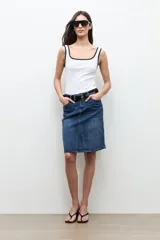 Falda midi de jean de corte recto y tiro medio, en tono azul medio con ligero efecto lavado y tajo frontal sutil.