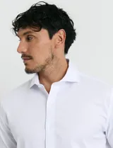 Camisa de vestir blanca de manga larga, con cuello clásico y cierre frontal de botones.