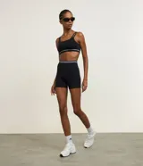 Bermuda deportiva Get Over de crossfit, color negro, con diseño seamless y rayas contrastantes blancas en la cintura alta.