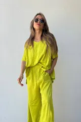 Conjunto color lima compuesto por un remerón de lino de corte holgado con cuello en V y un pantalón palazzo con cintura elástica.