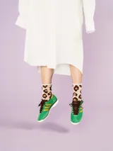 Medias color beige con estampado de manchas de leopardo pixeladas en marrón.