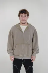 Canguro con cierre y capucha color marrón claro con efecto gastado y tres estrellas bordadas en el pecho.