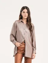 Camisa oversized con terminación metalizada, botones a tono en delantero, largo por debajo de la cadera y tajos a los costados.