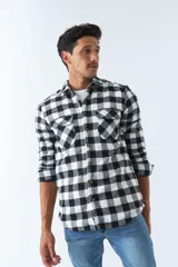 Sobrecamisa de algodón a cuadros color ladrillo, con interior de corderito, cierre con botones, bolsillos tipo cartera y logo en goma. El modelo usa talle M.