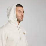 Canguro Wrangler color hueso, de corte regular, con capucha y bolsillo tipo canguro. Estampado frontal con el logo de la marca y el año de fundación.