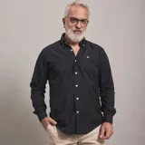 Camisa de vestir celeste a rayas verticales blancas, de corte clásico, con cuello abotonado y manga larga.